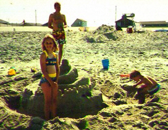 At the beach, on vacation with his children.